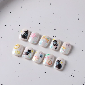 3D embossed cartoon cat nail stickers with pearl white base and floral bow designs
