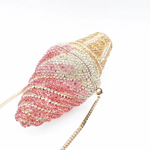 Macro detail of ice cream clutch with sparkling pink and gold crystals and metal chain