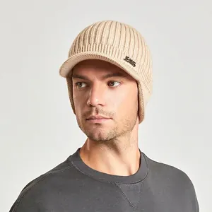 Winter knitted beanie with visor and ear protection for men in light beige