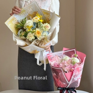 Detail of waterproof flower bouquet paper with ROMANTISM print and pearl edge texture