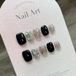 Handmade press-on nails with black gradient star pattern and silver glitter accents