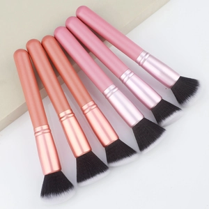 Macro shot of 6-piece rose gold makeup brush set with gradient synthetic fiber bristles