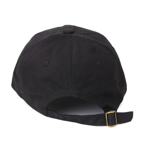 Close-up of the adjustable strap and gold metal buckle on a black cotton baseball cap