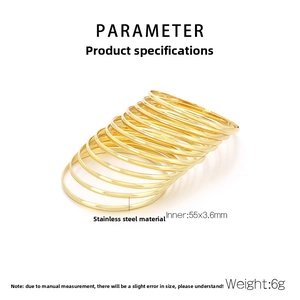 Macro detail of 3.6mm polished 18k gold plated stainless steel stacked bangles with specs