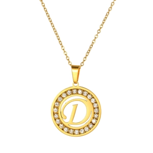 Detail of a gold-plated necklace featuring a crystal-set circular pendant with letter D