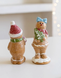 Close-up of resin gingerbread man figurines with frosted texture and festive accessories