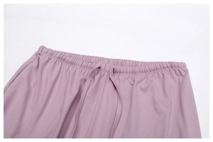 Detail of mauve yoga pants with elastic drawstring waist and soft brushed fabric texture