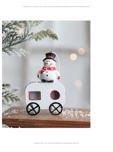 Detail of Christmas snowman on white vintage camper ornament with festive bokeh background