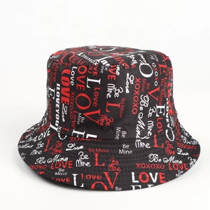 Detail of black reversible bucket hat with red and white love themed graffiti prints
