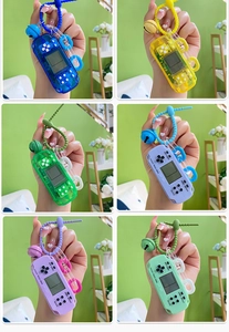 Collage of colorful mini Tetris game console keychains with bells in six different shades