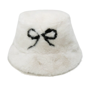 Close-up of plush white bucket hat featuring a decorative black bow embroidery detail