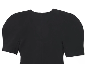 Close-up of women's black dress featuring puff sleeves and back invisible zipper detail