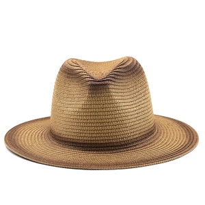 Detailed view of woven straw sun hat with gradient brown finish and pinched crown design