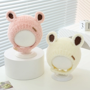 Detail of plush baby winter hats with cute bear ears and stylish leather fashion label