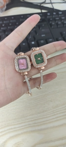 Close-up of rose gold square quartz watches with rhinestone bezels and bracelets