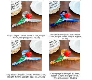 Detail showing tulip hair claws in grey, navy, sky blue and champagne colors