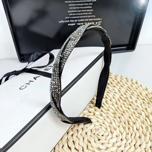 Detailed close-up of braided headband featuring shimmering grey and silver rhinestones