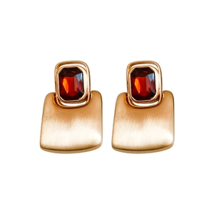 Rectangular brushed gold earrings with a vibrant red gemstone on a clean white background