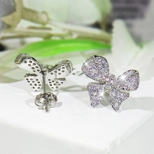 Detailed macro view of bow-shaped stud earrings with shimmering pave set crystals