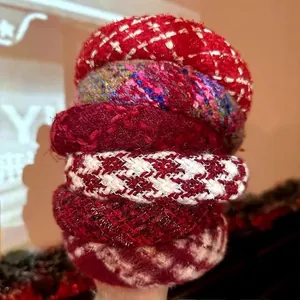 Close-up of red tweed and plush fabric scrunchies set with metallic thread detail