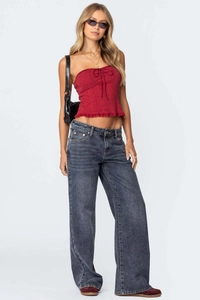 Close-up of wide-leg dark blue washed denim jeans and burgundy textured tube top set