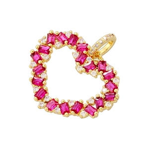 Close-up of gold-plated heart pendant with red rectangular and clear round crystals