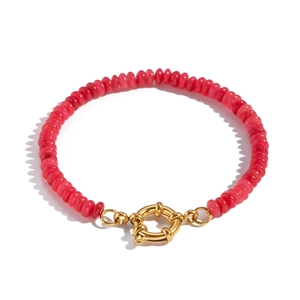 Detail of pink translucent beads and gold spring clasp on a beaded bracelet
