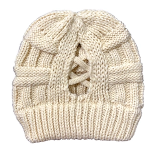 Detail of hollow-out crisscross design on off-white chunky knit ponytail beanie hat
