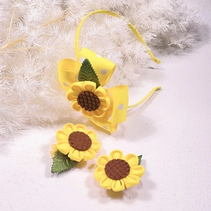 Detail of yellow sunflower headband and hair clips set for girls with polka dot patterns