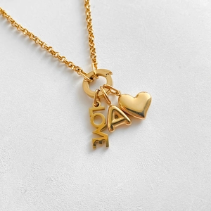 Detail shot of 14K gold plated necklace featuring LOVE, heart and letter A charms.