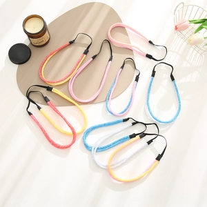Detail showing eight sparkling glitter headbands in assorted colors with elastic bands