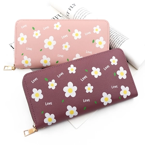 Detail of pink and burgundy long wallets with white daisy prints and LOVE text on PU leather