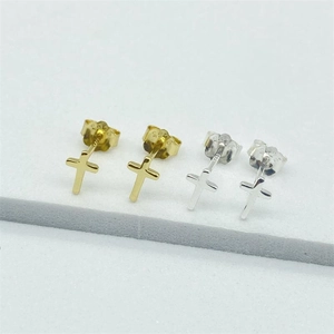 Close-up of S925 sterling silver cross studs with hallmark details in gold and silver