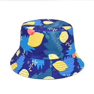 Close-up of lemon print details on a navy reversible bucket hat for sun protection