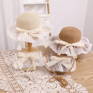 Detail of straw hat and bag set with delicate white lace trim and sweet bows for girls