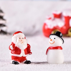 Miniature Christmas resin figurines of Santa Claus and a snowman for festive tabletop decor