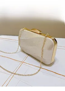 Detailed macro view of champagne gold evening bag showing sequin texture and gold metal clasp