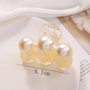 Close-up of 6.5cm beige transparent hair claw clip with three large white pearls