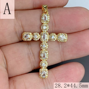 Detailed view of gold plated hip hop cross pendant with iced out cubic zirconia stones