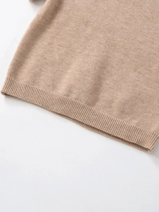 Detailed macro shot of the khaki knit sweater's ribbed hem and soft wool-like texture