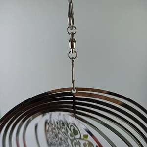Detailed macro view of the rotating swivel hook and top of the Tree of Life wind spinner