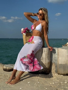 Three-piece floral print bikini set with a sheer mesh maxi skirt for beach vacations