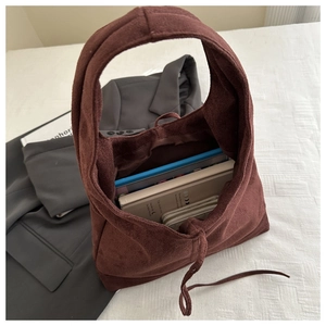 Brown suede tote bag interior showing large capacity for books and personal items