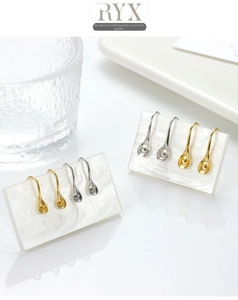 Detail of creative spoon-shaped S925 silver earring hooks in gold and silver finishes