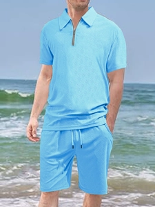 Detail of light blue men's waffle texture polo shirt and shorts set for summer