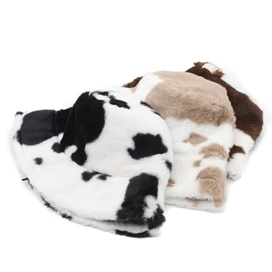 Winter plush bucket hats with cow print patterns in three different color combinations