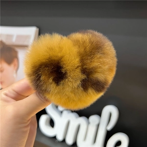 Macro shot of fluffy leopard print heart-shaped hair clip with soft plush texture