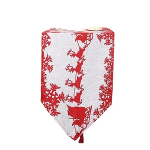 Christmas table runner with red reindeer and snowflake patterns and tassel trim