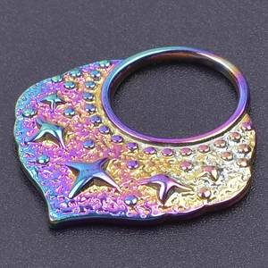 Detailed macro view of 18k gold plated stainless steel star pendant with PVD rainbow finish