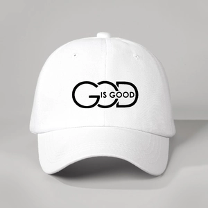 Detailed view of the GOD IS GOOD black print on white cotton adjustable baseball cap